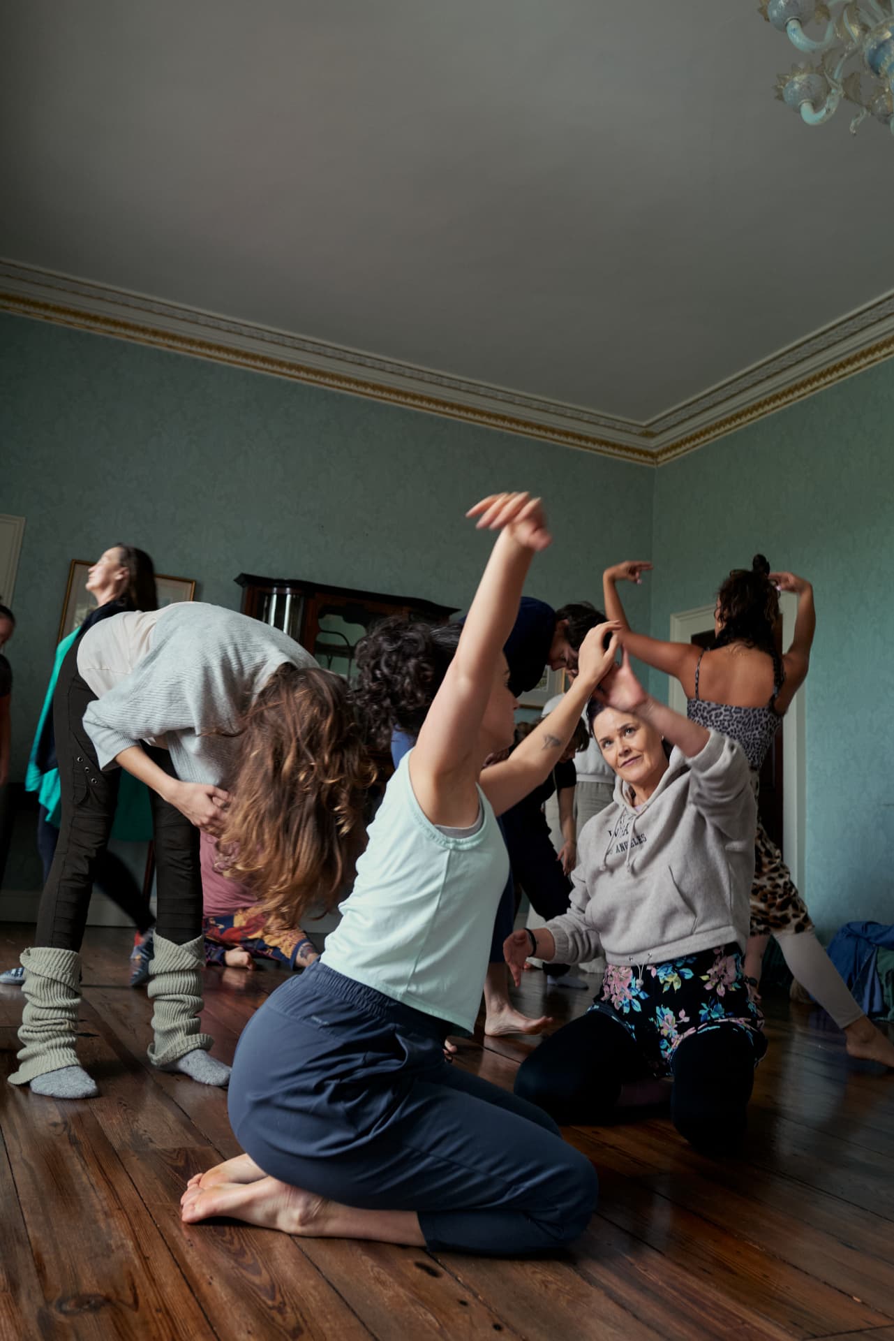 A group moving freely together in a sage-walled room